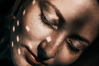 Close-up portrait of a woman. disco-ball flashes on a girl's face