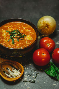 Rustic tomato basil soup onion tomato wood spoon cheese melted warm