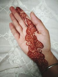 High angle view of woman hand with tattoo