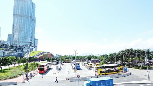 Cars on street by buildings against sky