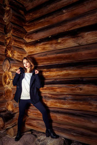 Woman standing in log cabin