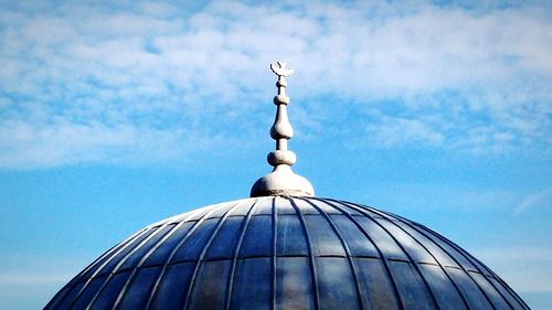 High section of built structure against blue sky