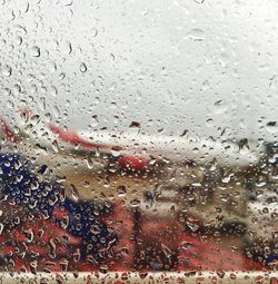 Full frame shot of wet glass window in rainy season