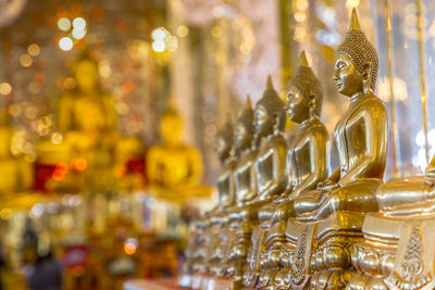 Close-up of buddha statues in temple