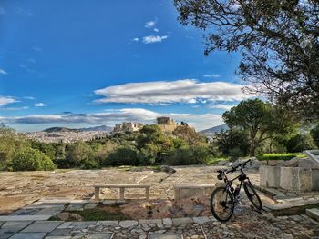 Bicycle on footpath against sky