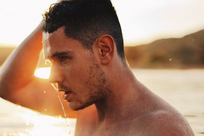 Close-up portrait of shirtless young man