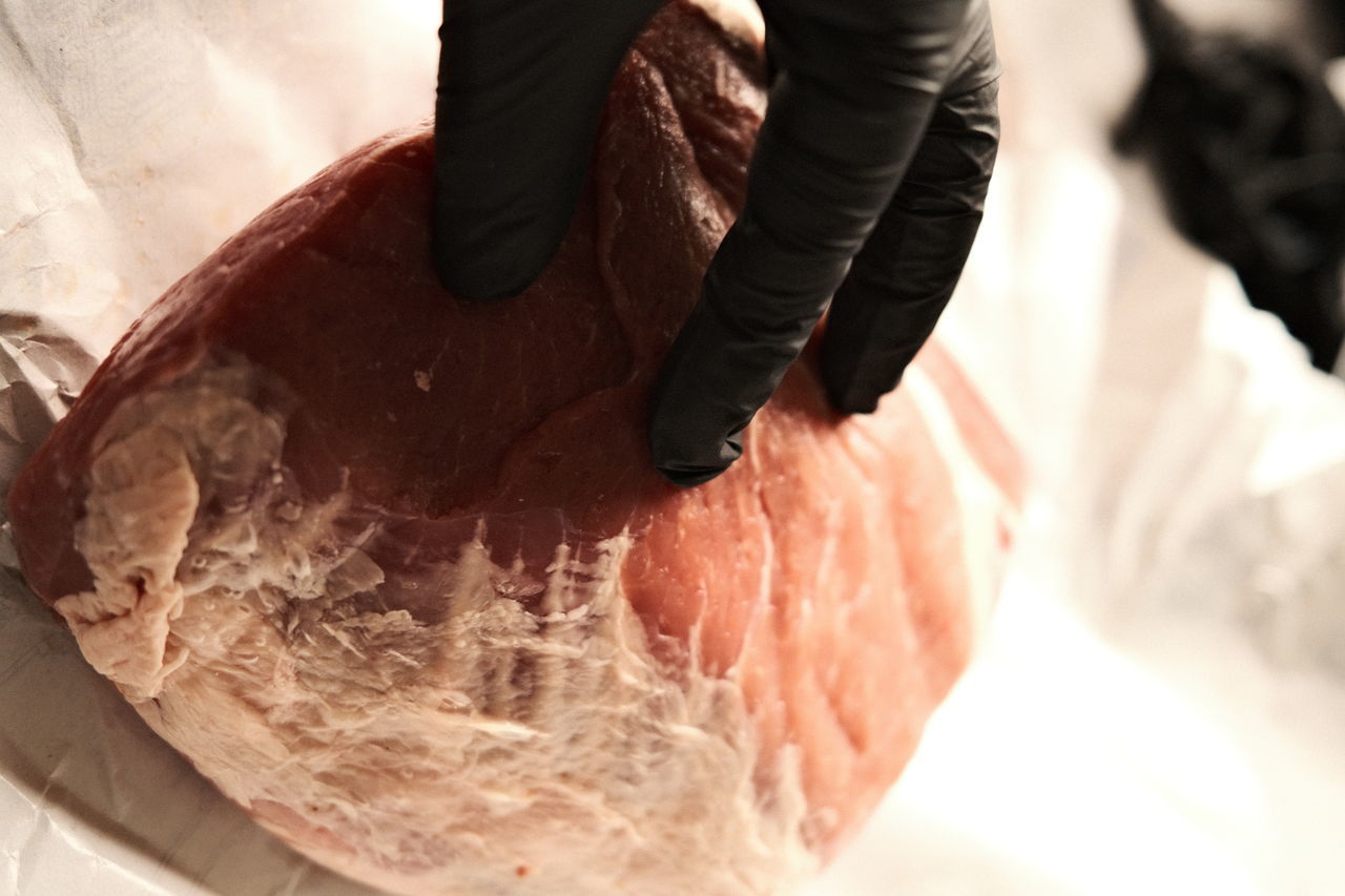 HIGH ANGLE VIEW OF PERSON PREPARING BREAD