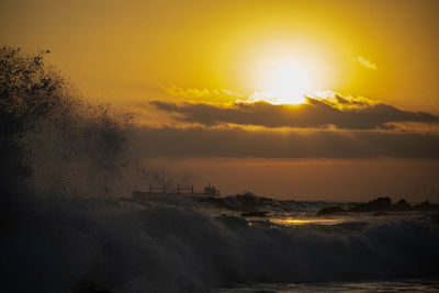 Scenic view of sea against orange sky