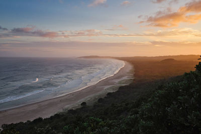 Scenic view of beach against sky during sunset