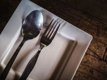 High angle view of fork in plate on table