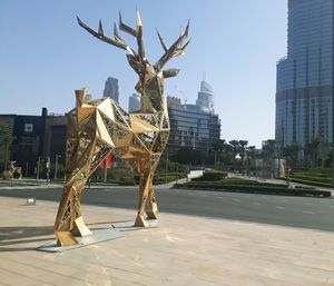 Statue of modern building against clear sky