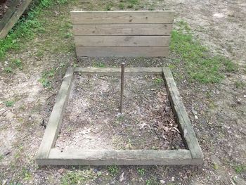 High angle view of empty bench in field