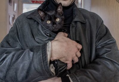 Portrait of man with cat