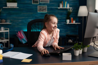 Young businesswoman using laptop at table