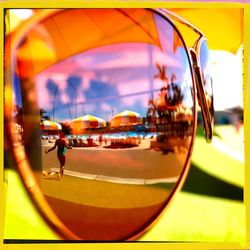 Close-up of wine glasses against sky