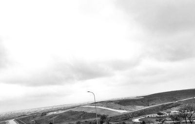 Road by mountain against sky