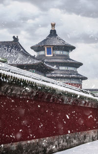 Traditional building against sky during winter