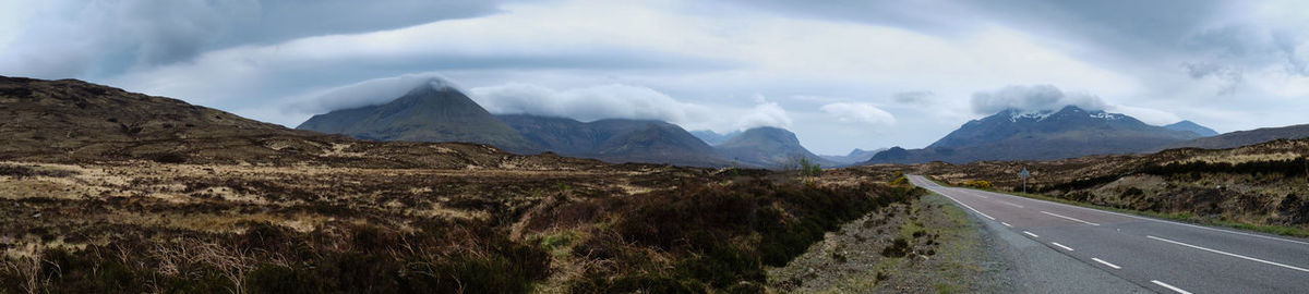 Panoramic view of road amidst mountains against sky