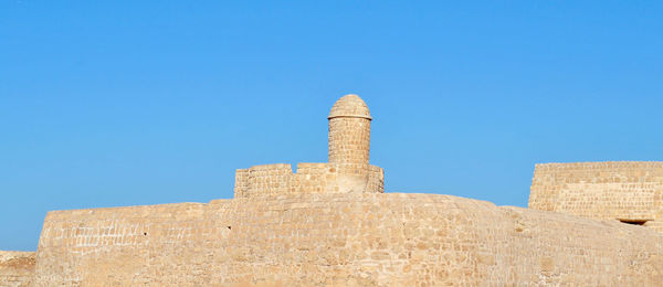 Low angle view of fort against blue sky