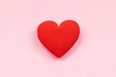 Close-up of red heart shape against white background
