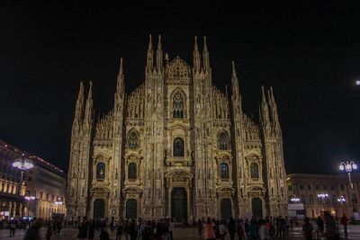 Group of people in front of building at night