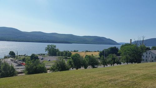 Scenic view of landscape and mountains against clear blue sky