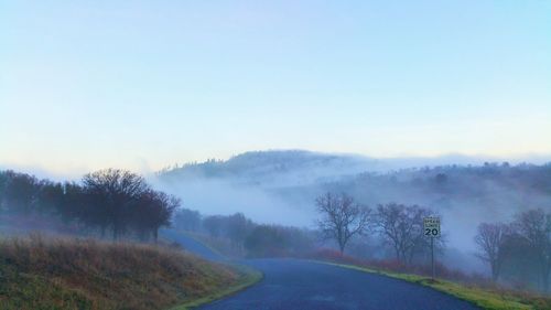 Road passing through foggy weather