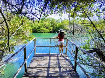 Woman standing on observation point over river