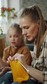 Close-up of mother and daughter at home