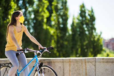 Young woman riding bicycle