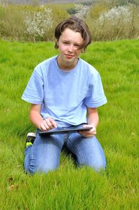 Boy sitting on field