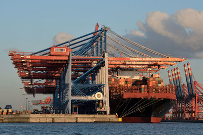 Commercial dock by sea against sky