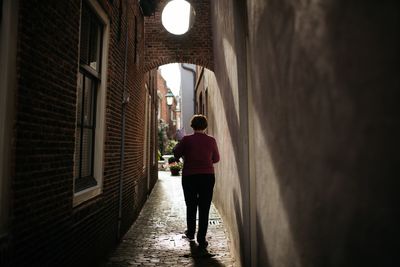 Rear view of man walking in corridor