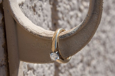 Close-up of heart shape hanging on metal wall