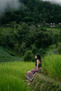 Rear view of woman standing on field