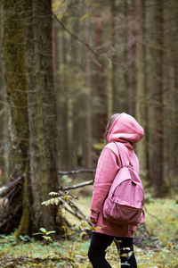 Rear view of woman walking in forest