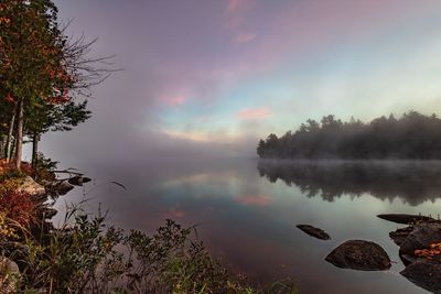 Scenic view of lake against sky during sunset