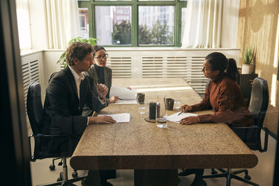 Female friends using laptop at home