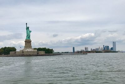 Statue of liberty against cloudy sky