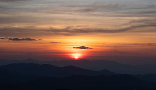 Scenic view of silhouette mountains against sky during sunset