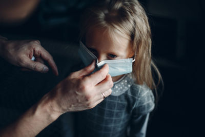 Close-up of man holding mask of girl