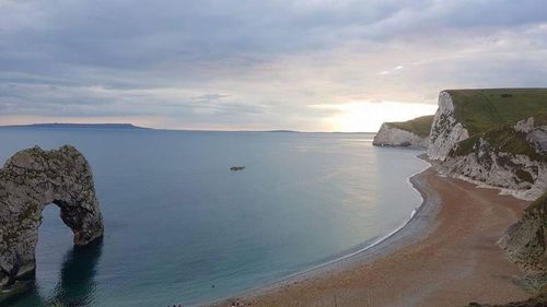 Scenic view of sea against sky at sunset