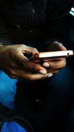 Close-up of man using mobile phone