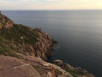 High angle view of rocks by sea against sky