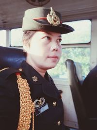 Woman wearing uniform while sitting in bus