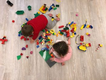 High angle view of children playing with toys on floor