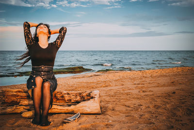 Young woman sitting on beach