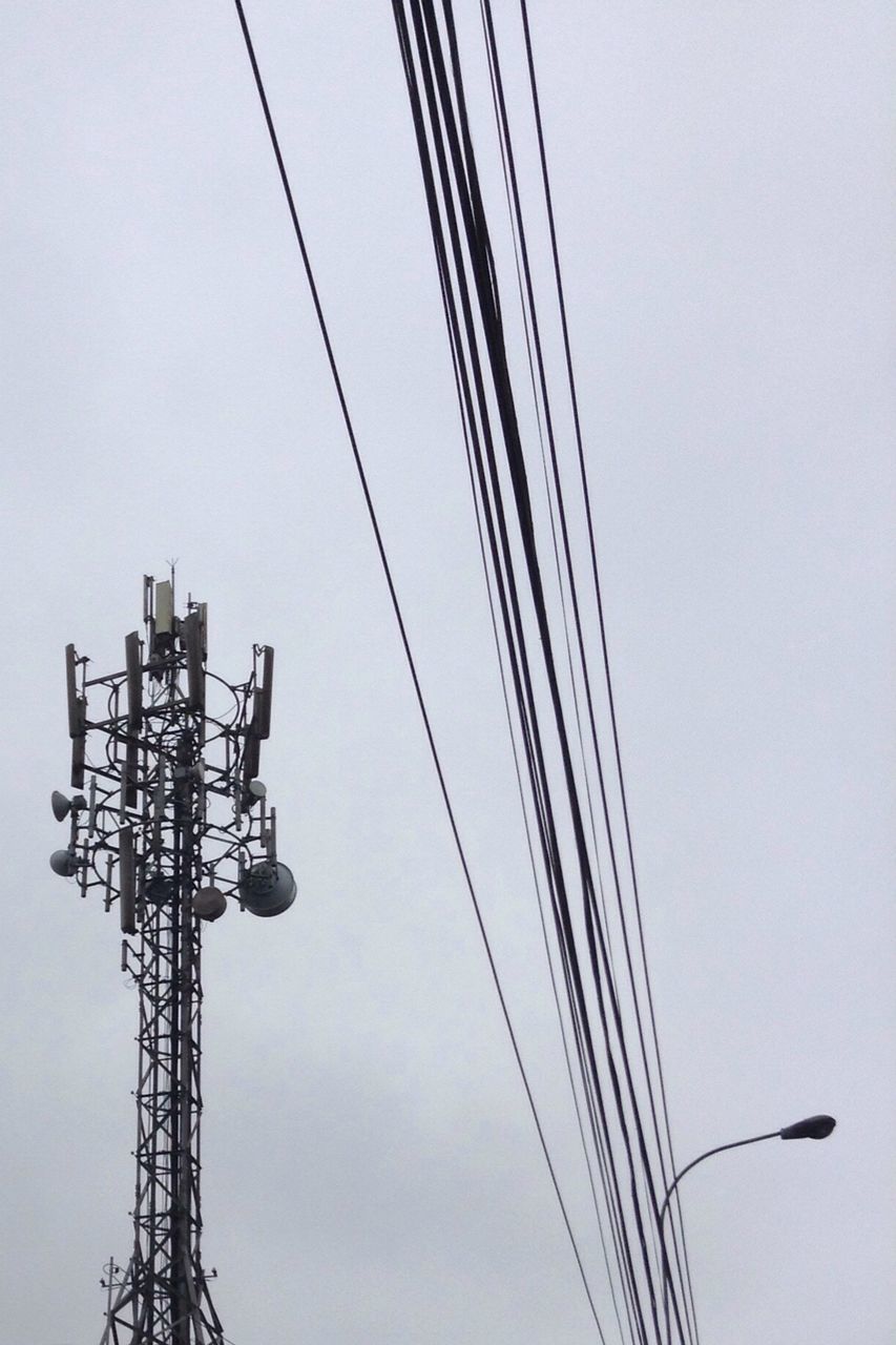 low angle view, power line, electricity, connection, electricity pylon, technology, power supply, cable, silhouette, fuel and power generation, sky, clear sky, tall - high, development, outdoors, crane - construction machinery, no people, electricity tower, day, copy space