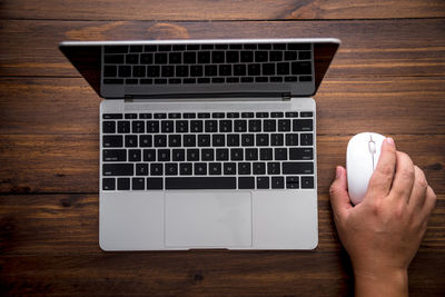 Low section of person using laptop on table