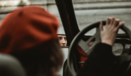 Rear view portrait of man seen through car window